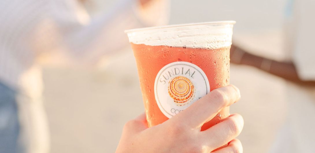 Handing a Sundial tea cup off on the beach